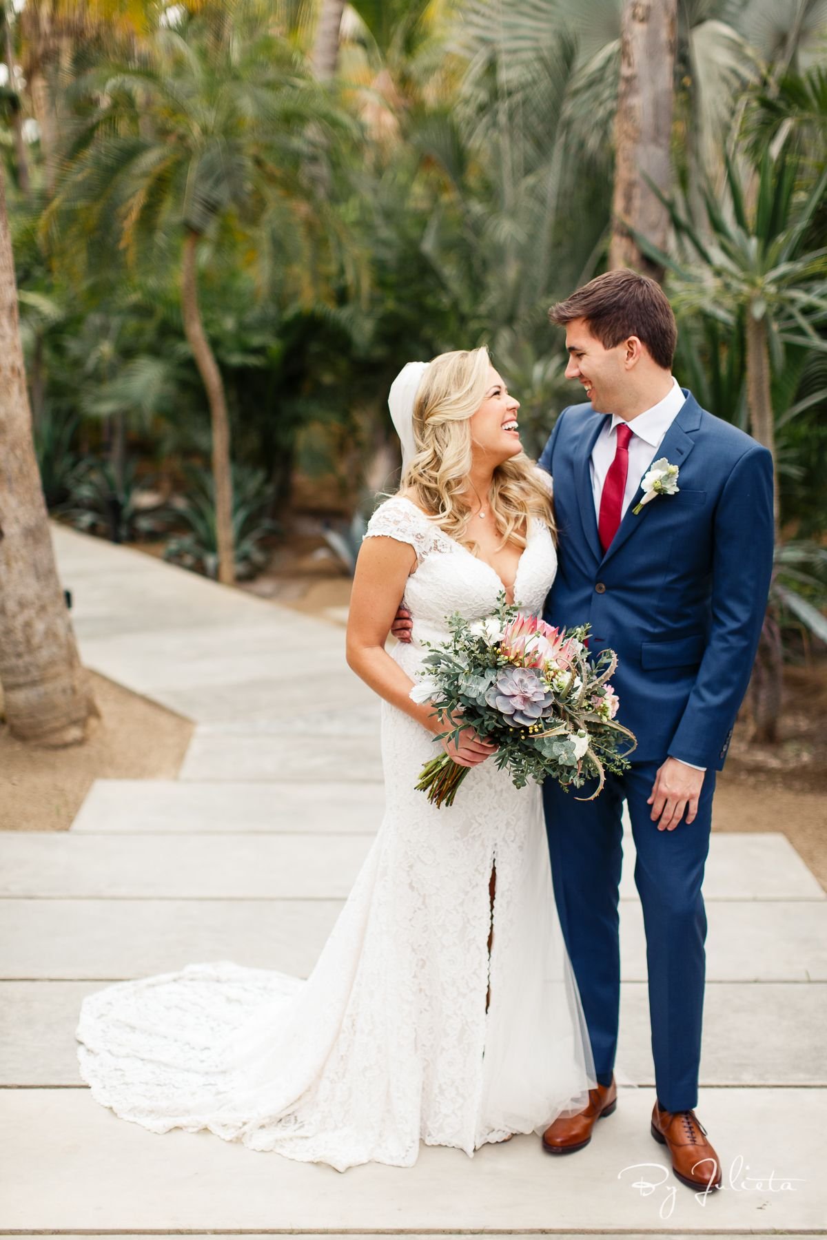 Bride and Groom and Acre Baja Wedding Venue in Cabo San Lucas. The Bridal Bouquet the Bride has is a design by Jesse Wolff