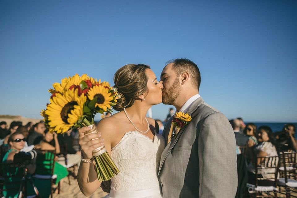 Bride and groom kissing after ceremony at sheraton hacienda del mar in los cabos by cabo wedding services