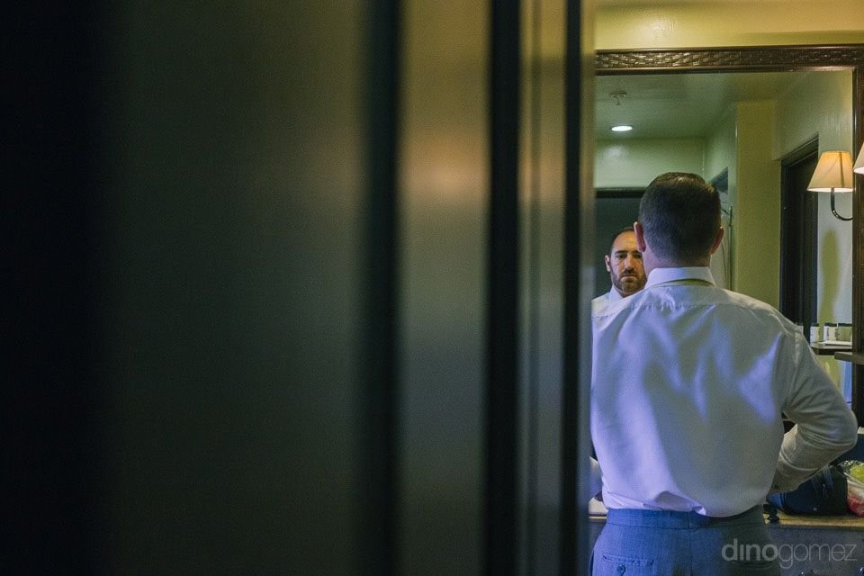 Groom getting ready in room at Sheraton Hacienda del Mar