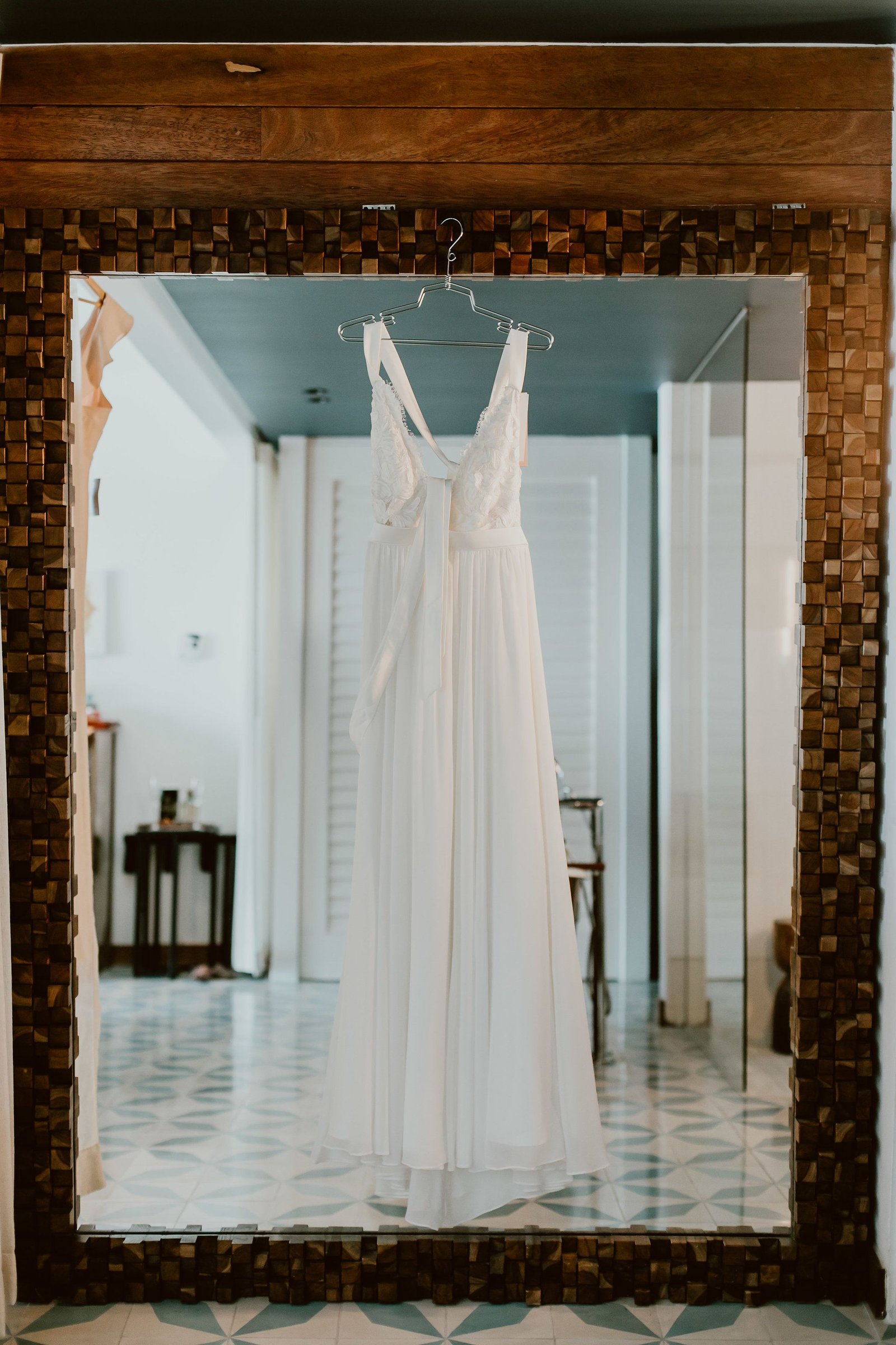 Brides dress hung at The Capes hotel room in Los Cabos Mexico