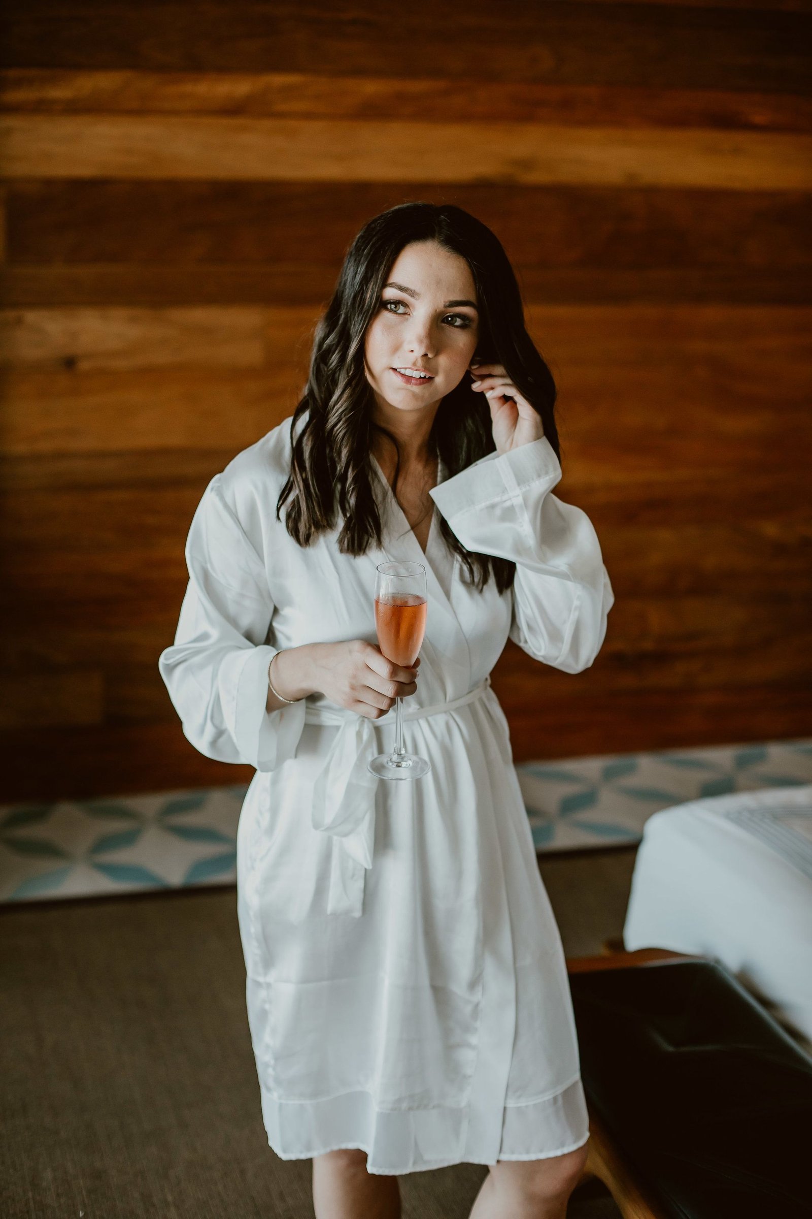 Bride drinking champagne with her bridesmaids getting ready in her hotel room at the Cape in Cabo San Lucas Mexico