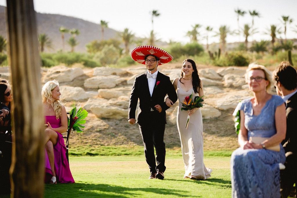 Bridal Party walking down the aisle during the Wedding Ceremony before the bride walks down. This is at Cabo del Sol Venue in Los Cabos Mexico. Wedding Planning and design by Cabo Wedding Services