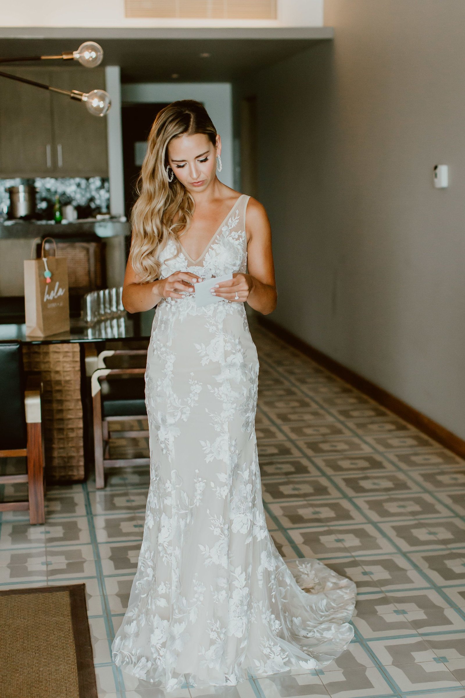 At this moment, the Bride is reading the letter that her groom sent her prior to seeing each other at the Ceremony. This is always a great detail to do if you want the photographer to capture great expressions and emotions before the Ceremony time. Wedding Planning by Cabo Wedding Services at the Cape by the Thompson Hotels in Cabo San Lucas