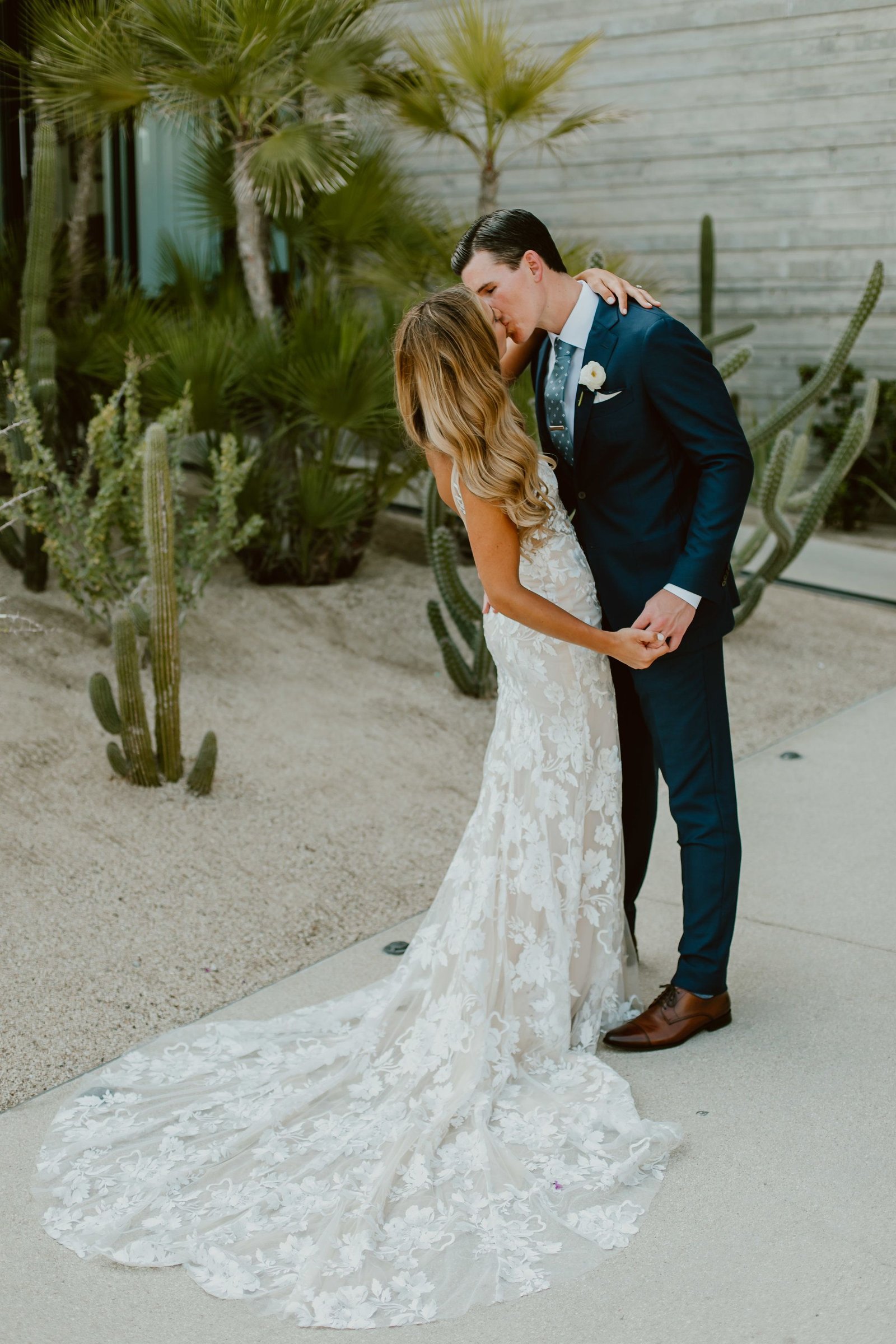 Bride and Groom kissing after doing their First Look. This blog has all you need to know about doing a First look. The pros and the cons to what brides always ask themselves when they begin the wedding planning. This photo was taken at The Cape by Thompson Hotels in Los Cabos, Mexico.