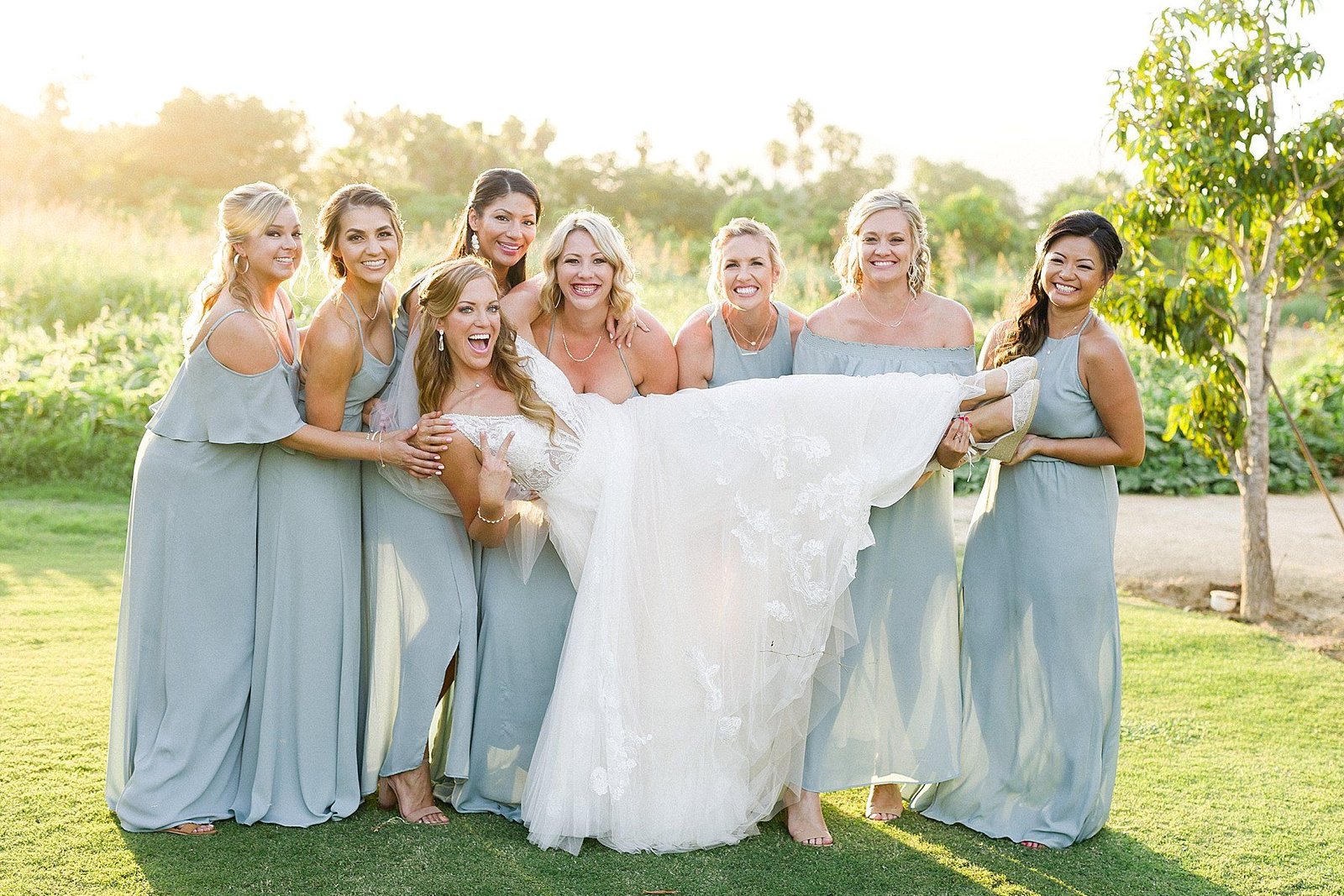 Bride with Bridesmaids hanging out after the Ceremony at Flora Farms in Los Cabos, Mexico.