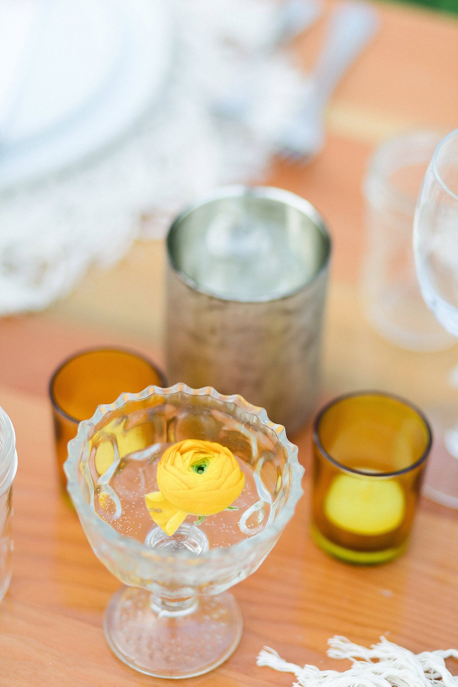 Cute little Votives with touches of pop flowers on the Tables. Wedding Venue was at Flora Farms in Los Cabos, Mexico. Wedding Planning was done by Cabo Wedding Services, and photography was done by Sara Richardson Photography. 