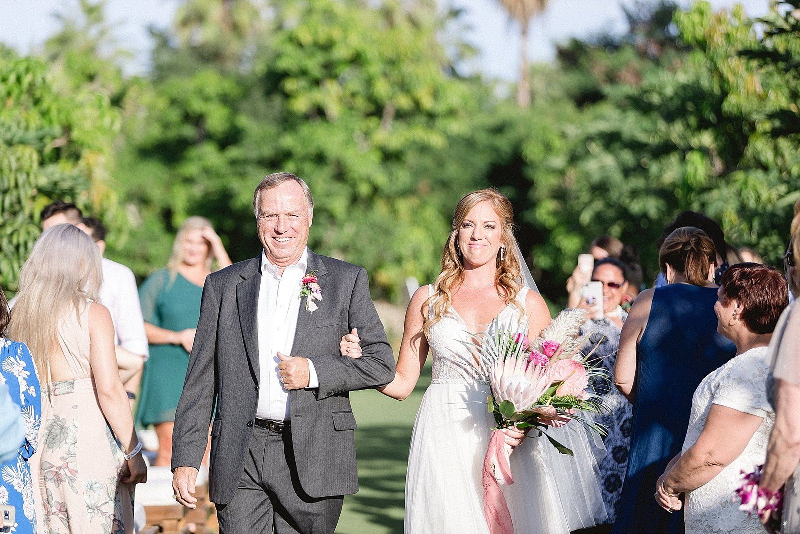 Bride walking down the aisle at Flora Farms to her Ceremony Alter. Wedding Design and planning by Cabo Wedding Services. Wedding Venue Flora Farms in Los Cabos, Mexico. 