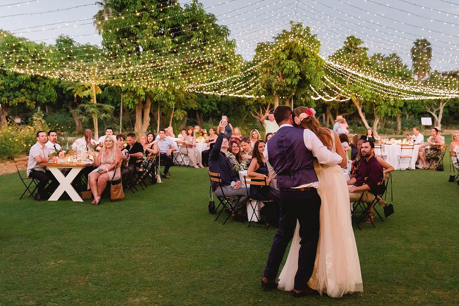 Bride and Groom looking at their wedding reception at Flora Farms. Wedding Venue in Cabo San Lucas, Mexico. Wedding Photography by Sara Richardson and Wedding Planning by Cabo Wedding Services