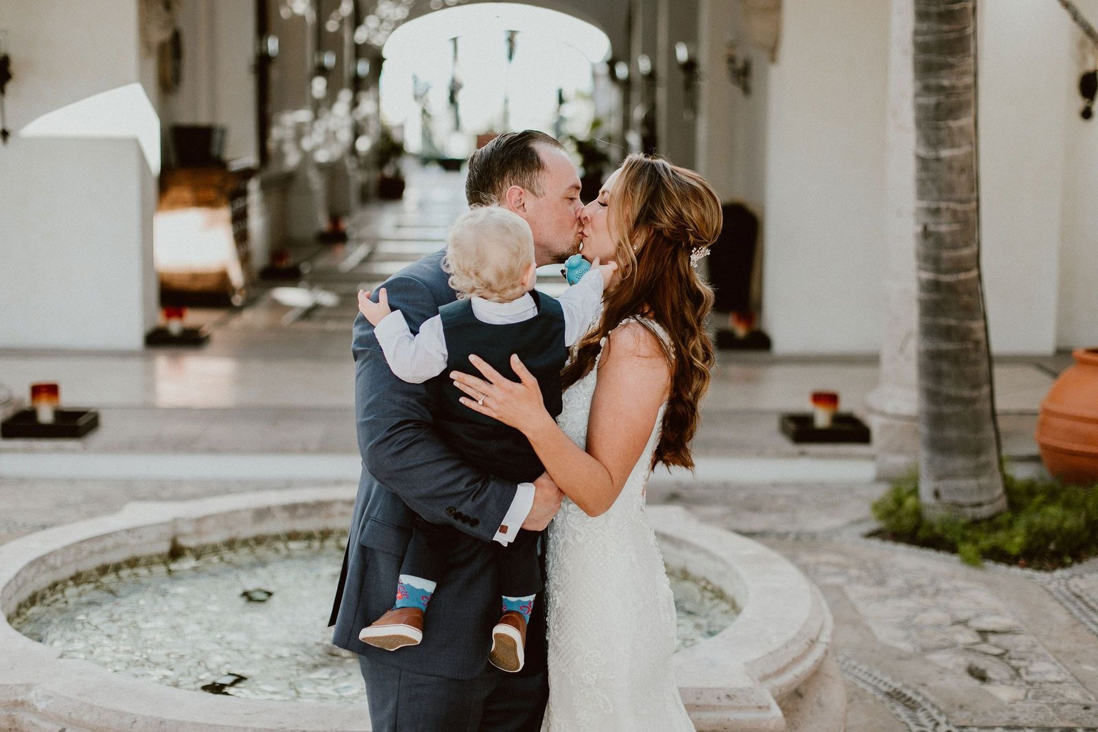 Bride and Groom kissing at their wedding in Los Cabos Mexico. Destination Wedding at Cabo del Sol. Wedding Planners Cabo Wedding Services and Ana and Jerome Photography. They hired Emporio Floral art for Flowers.