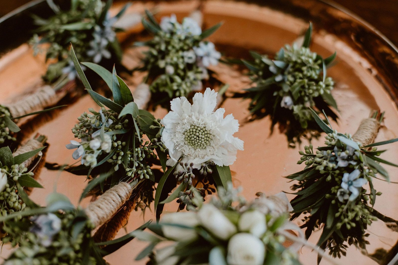 Groom's boutonniere with Groomsmens boutonnieres. This wedding was in Cabo San Lucas, Mexico. Wedding Planning by Cabo Wedding Services. Photography by Ana and Jerome. Wedding was at Cabo del Sol.