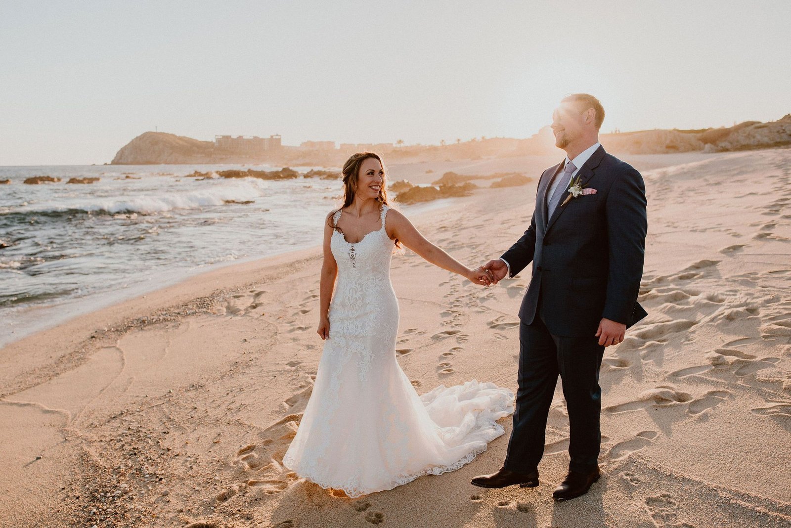 Bride and Groom at the Beach in Los Cabos, Mexico, at their Destination wedding. Wedding Planning by Cabo Wedding Services. Wedding design by Jesse Wolff and Wedding Photography was done by Ana and Jerome, who are also local Wedding Vendors in Cabo San Lucas. Cabo del Sol, where Ian and Jen got married at, is a venue in Los Cabos, famous for their weddings they do year around.