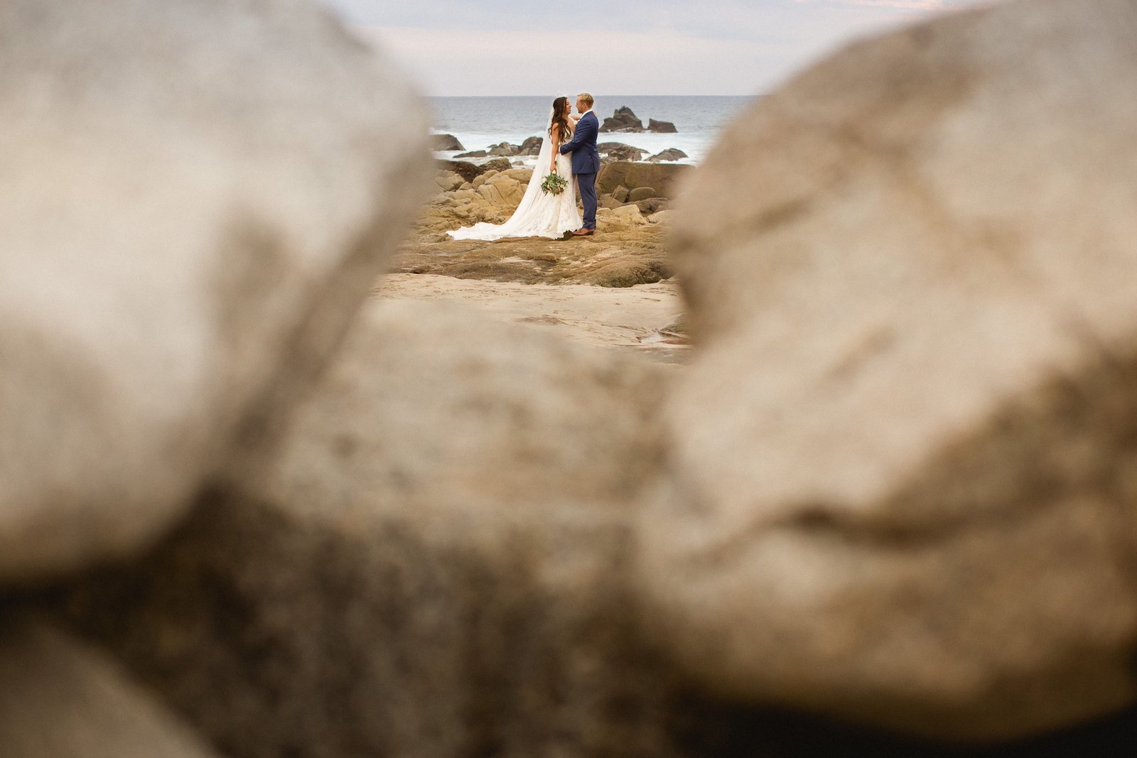 Bride and Groom during their photo session at the Beach in front of The Cape. Wedding Planning done by Cabo Wedding Services