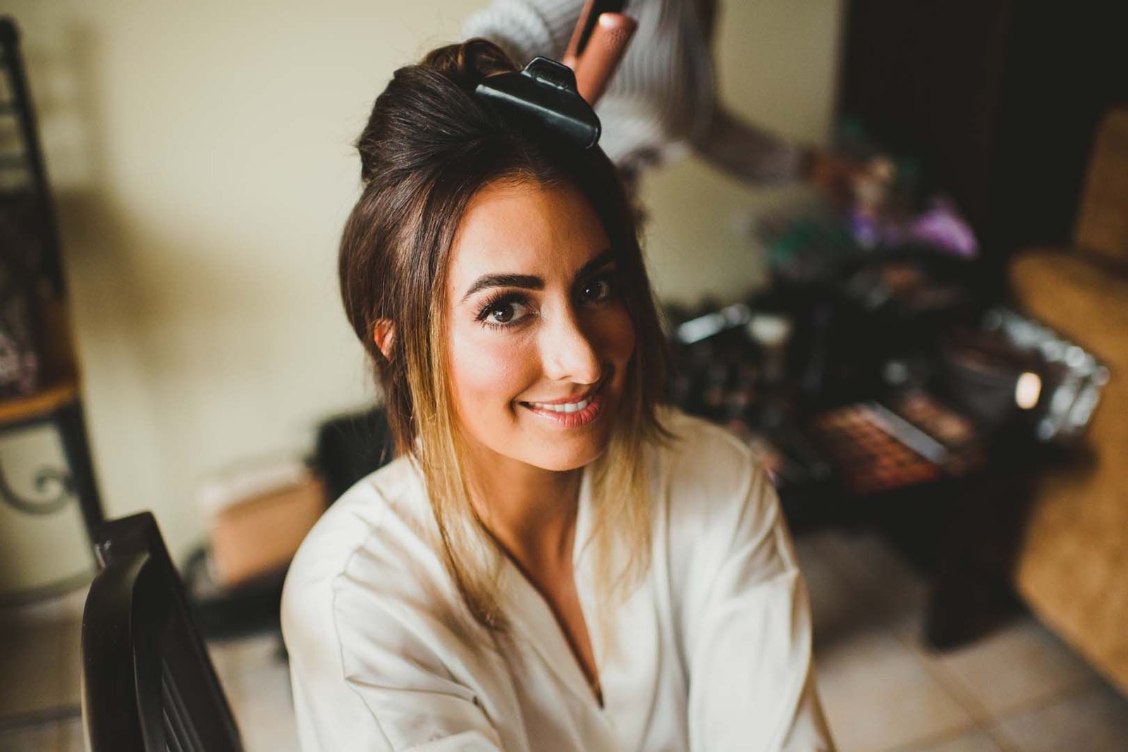 Bride Jessica getting her hair and makeup by Bri Berliner in her Hotel room at Villa del Palmar, hours before walking down the ceremony at the Evangelista Church in Los Cabos, Mexico.