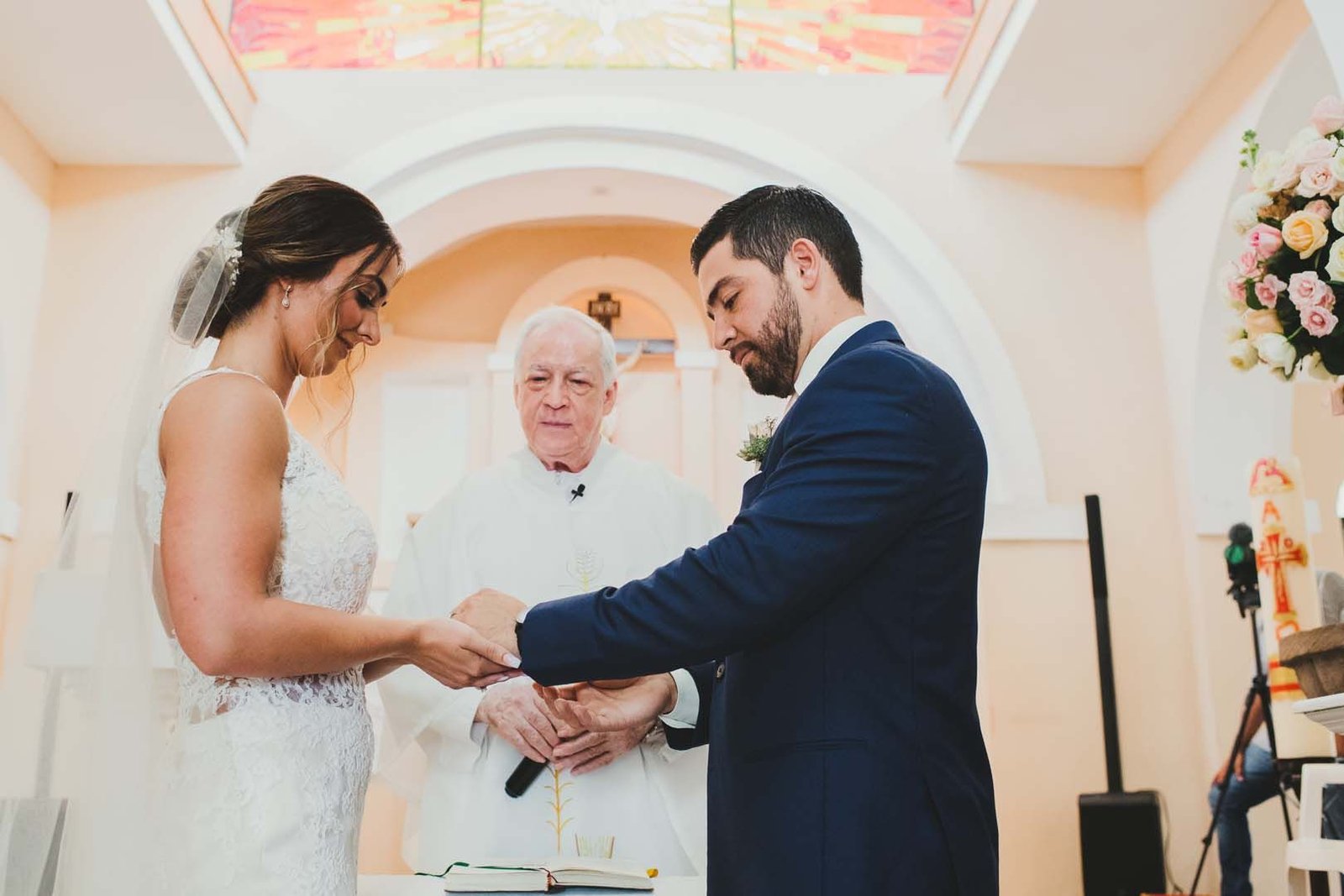 Bride and Groom praying during the mass of their wedding that took place at the Evangelista Church in Los Cabos Mexico.