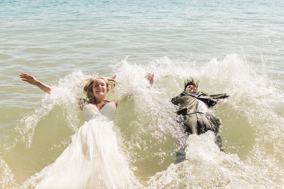 Bride and groom doing their trash the dress photo session, done by local Photographer Daniel Jireh. Wedding Planning done by Jesse Wolff from Cabo Wedding Services. Wedding venue at The Cape by Thompson Hotels.