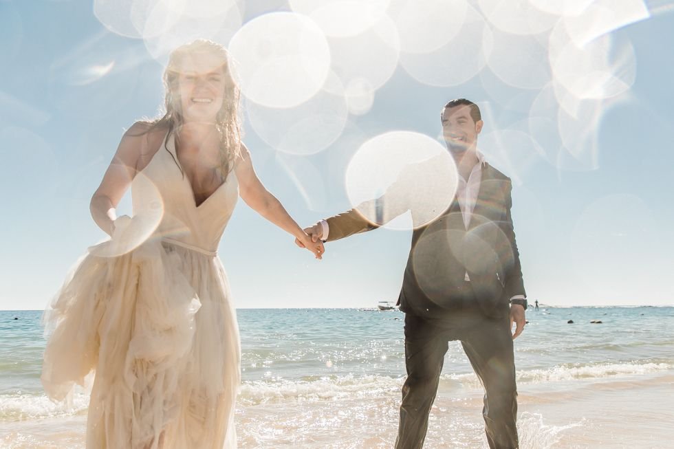 Bride and Groom photo session by Local Photographer in the Los Cabos Area, Daniel Jireh. He took the Bride and Groom to the beach to do a trash the dress session and the couple had so much fun! Wedding Planning was done by Cabo Wedding Services.