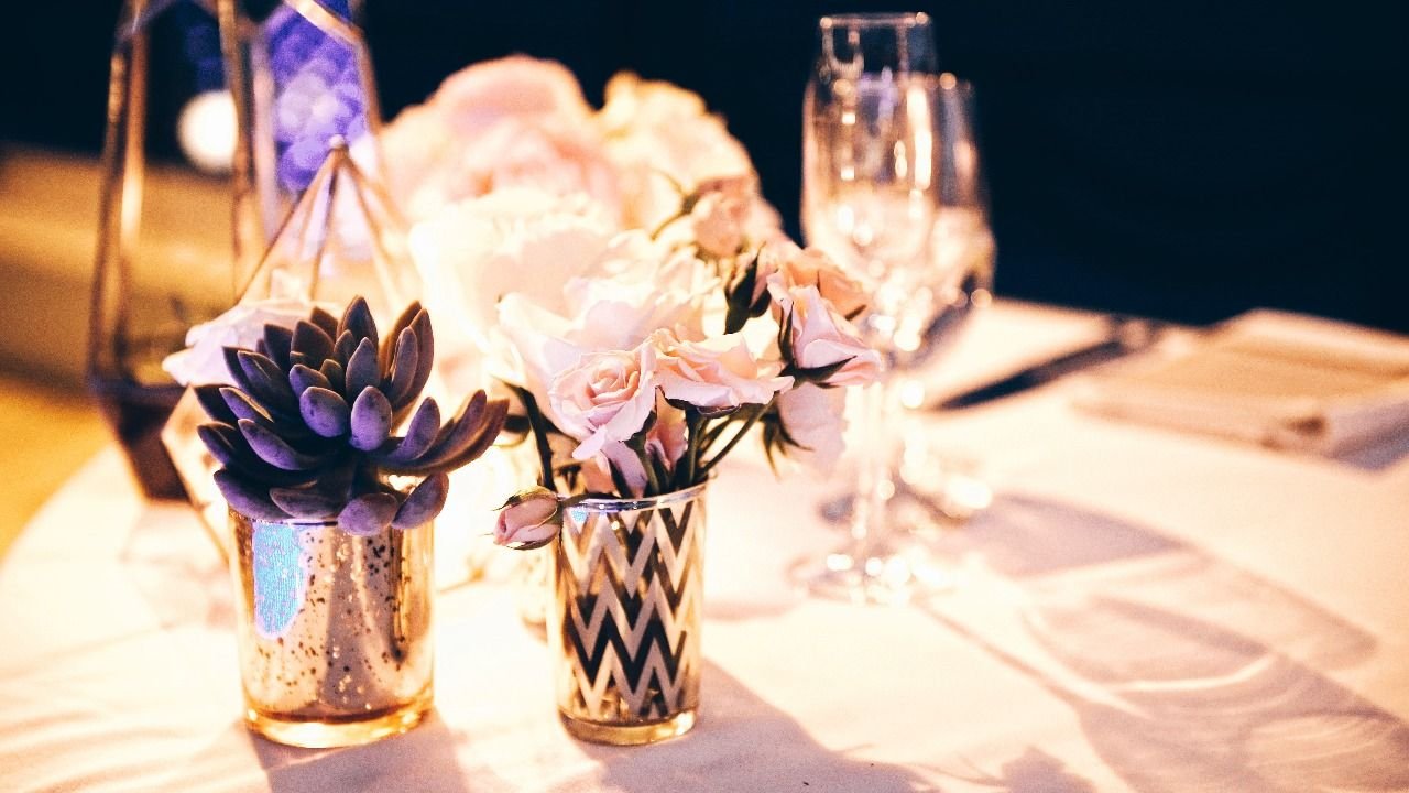 Little details of flowers on the wedding tables. They had roses and succulents, with beautiful candles