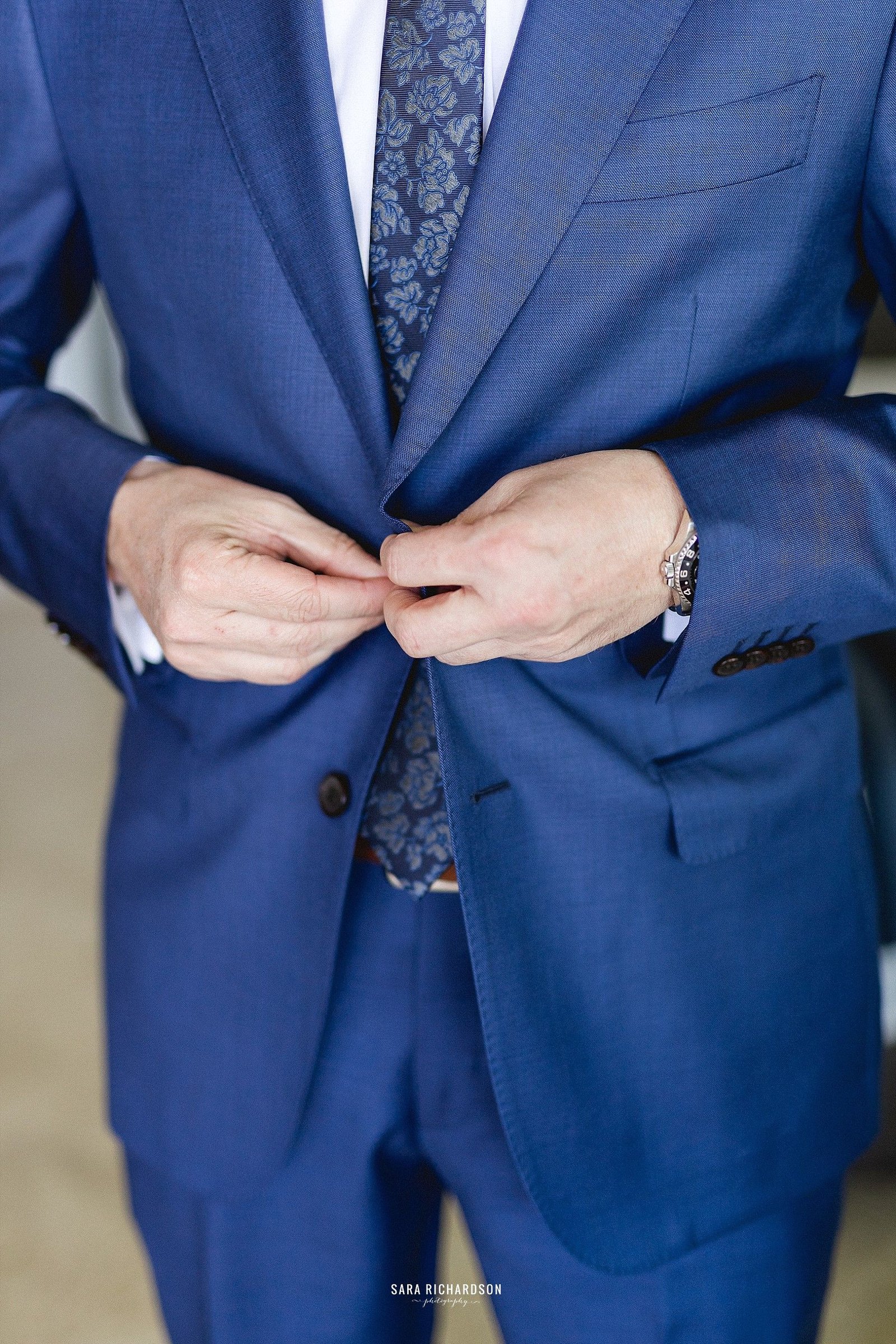 Groom getting ready at the Hilton Los cabos, in Cabo San Lucas, Mexico. They decided to have a Destination Wedding and their photographers were Sara Richardson and they decided to get married at Huerta Los Tamarindos in Los Cabos.