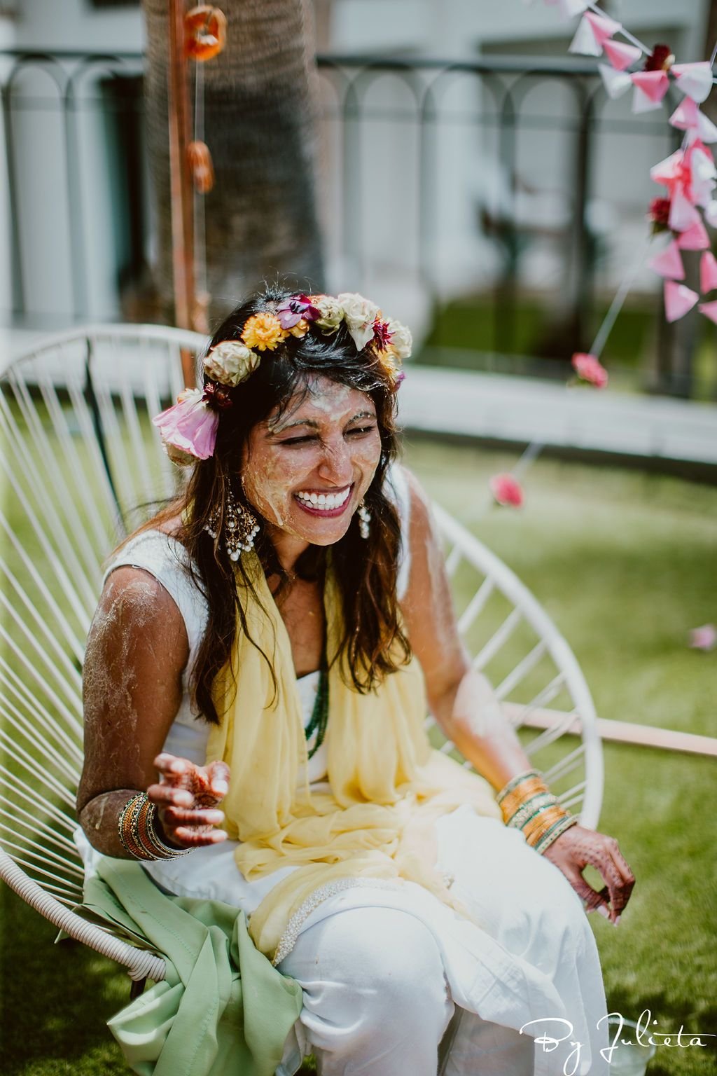 Bride getting turmeric on her by her friends and family, during the Haldi ceremony. This event took place in the morning, and we turned it into a breakfast, filled with festivities.