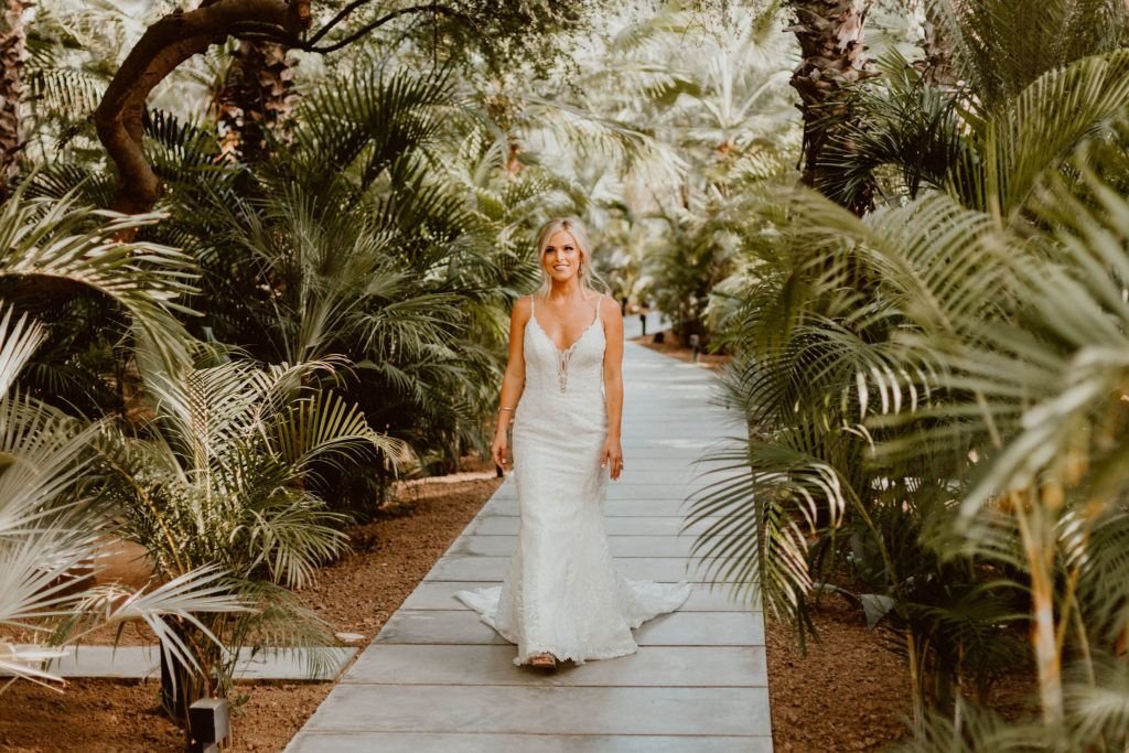 Bride walking down the path at Acre Baja ab out to see her groom for the first time, before the ceremony. They decided to do a First Look and were able to get pictures in before the Ceremony.