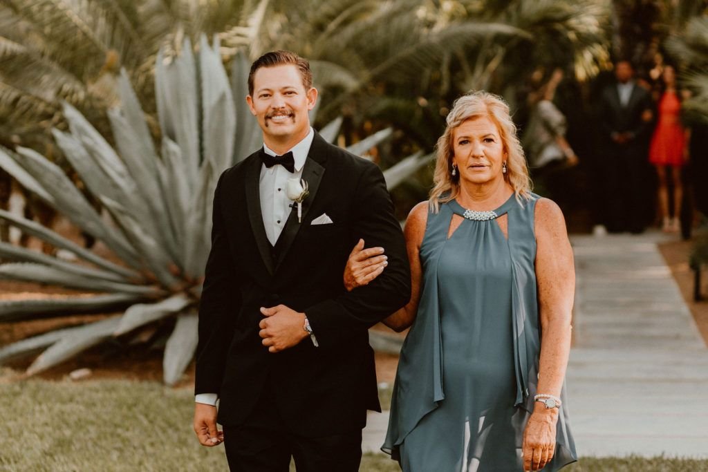 Groom walking down the Aisle with his Mother at his Destination Wedding Venue Acre Baja. Wedding Planning was done by  Jessica Wolff at  Cabo Wedding Services