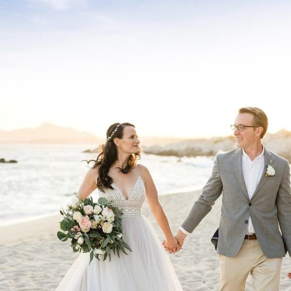 Bride and Groom walking on the beach after the Ceremony at The Cape in Los Cabos, Mexico