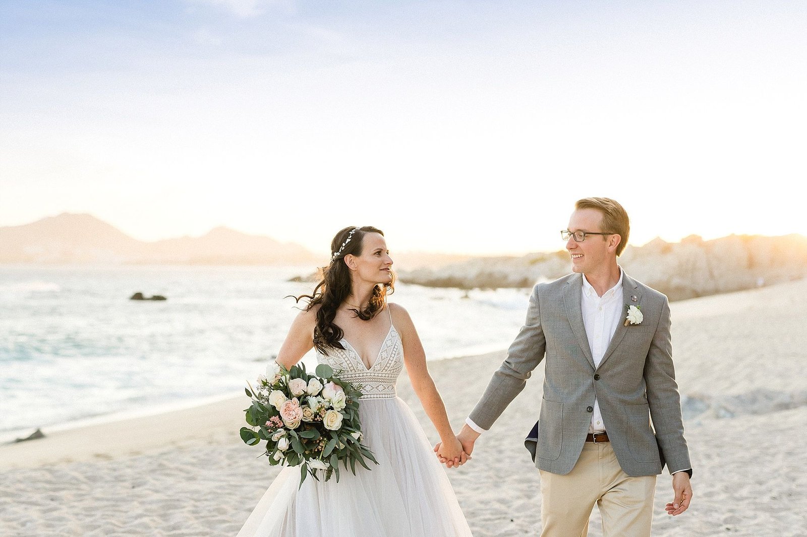 Bride and Groom walking on the beach after the Ceremony at The Cape in Los Cabos, Mexico