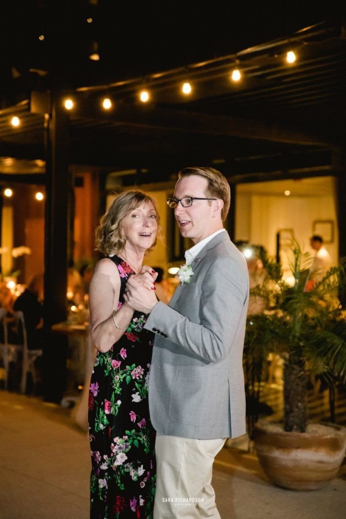 The groom is dancing with his mom at his Wedding, that took place at The Cape in Los Cabos, Mexico