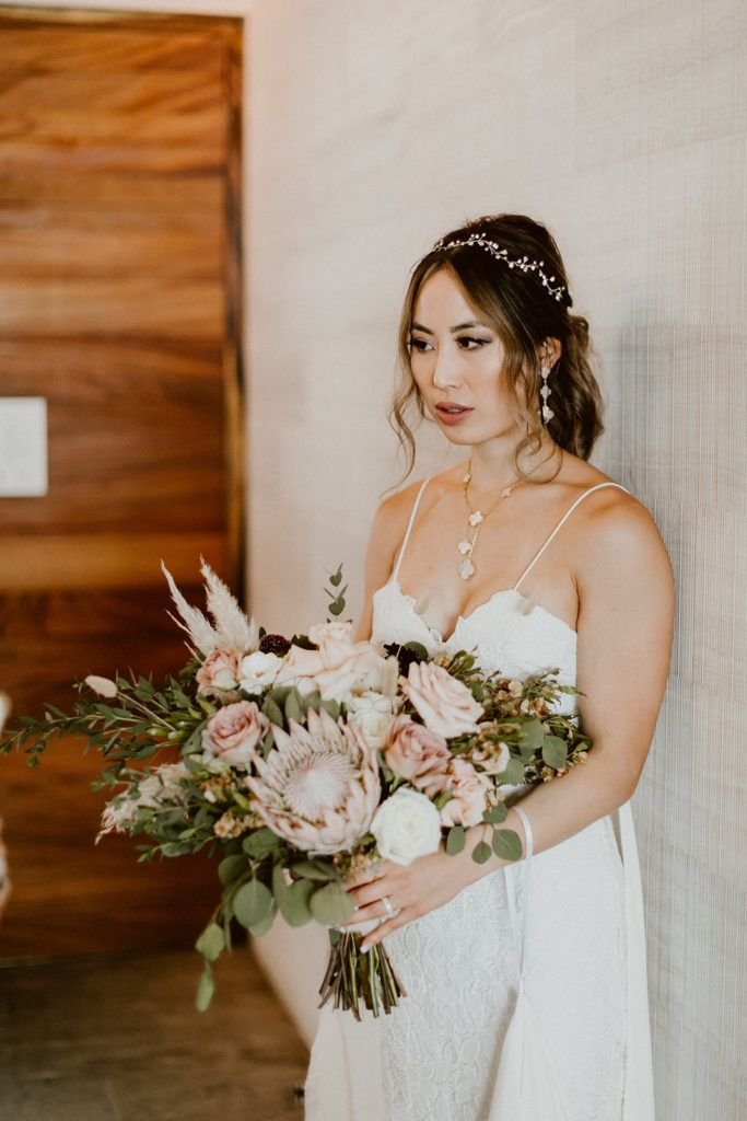 Bride holding her Bridal Bouquet made by Let it Be Events. The Wedding Venue took place at Solaz Los Cabos, a Luxury Resort in Mexico.