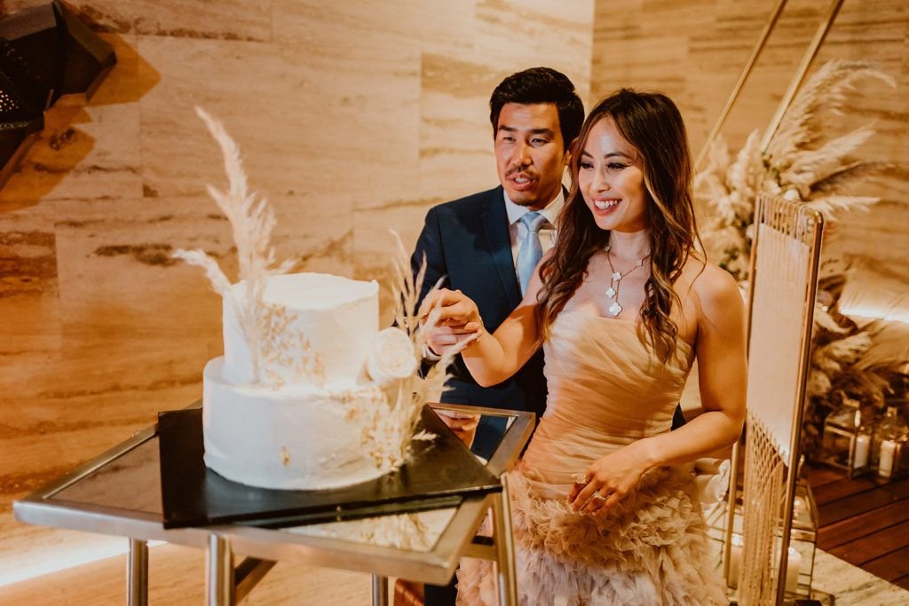 Bride and Groom cutting their Wedding Cake that was designed by the Wedding Venue they had their wedding at. The wedding venue was Solaz Luxury Resort in Los Cabos Mexico.