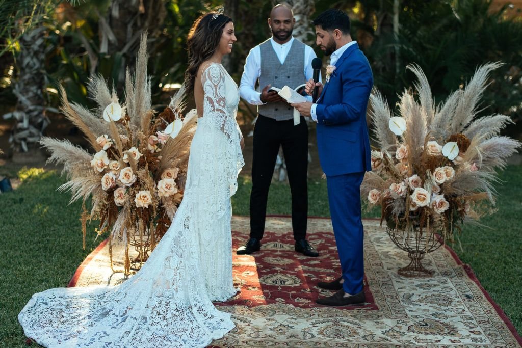 bride and Groom standing at the ceremony alter at their wedding venue at  Acre Baja in Los Cabos Mexico. They had one of their friends officiate the ceremony