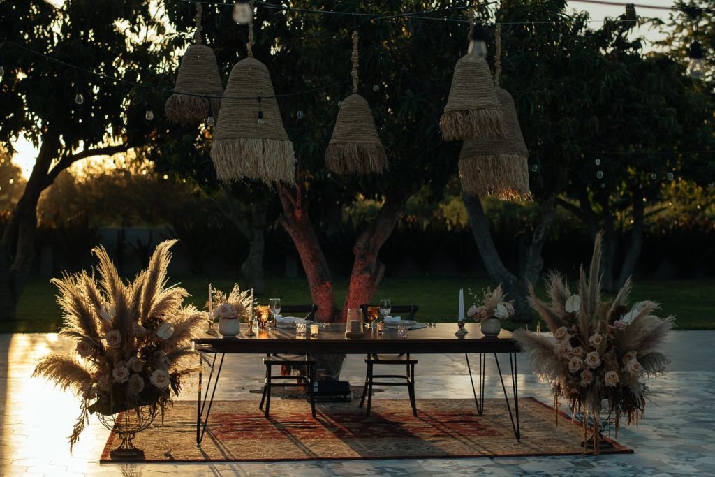 Sweetheart table designed by Jessica Wolff from Cabo WEdding Services. The wedding took place at Acre Baja in Los Cabos Mexico. The bride wanted to incorporate Pampas Grass and go for a very boho style and that is exactly what we did! We hung baskets above the sweetheart table and it look stunning!