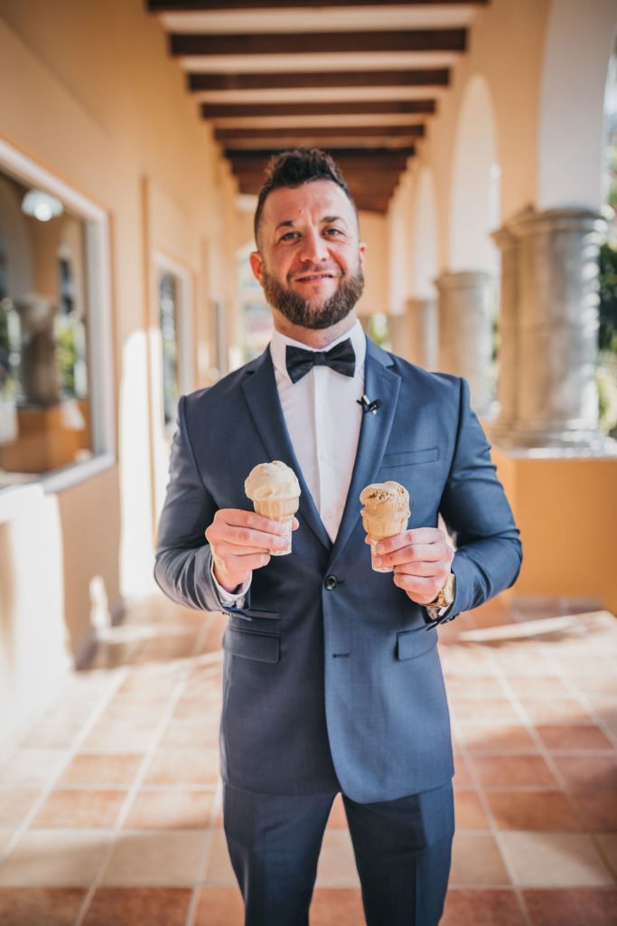 Groom holding ice cream waiting for his Bride to do the First Look at the Villa Group. This was a Destination Wedding in Los Cabos Mexico. The groom wore Armani Exchange. Wedding Planner was Jessica Wolff by Cabo Wedding Services.