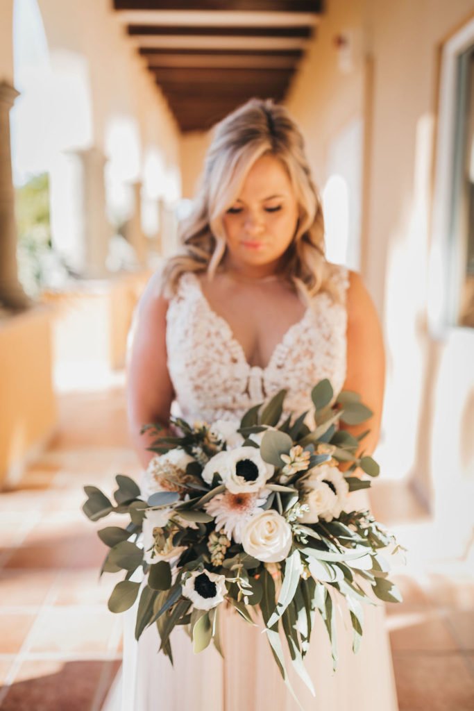 Bride holding her Bridal Bouquet prior to doing the First Look at the Villa Group. Wedding Planning was done by Jessica Wolff from Cabo Wedding Services  in Los Cabos Mexico. Destination Wedding in Cabo.