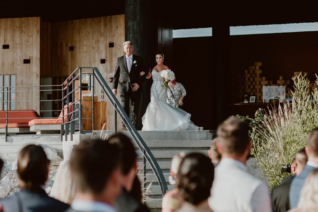 The Bride walking down to the ceremony to see her husband for the first time. 