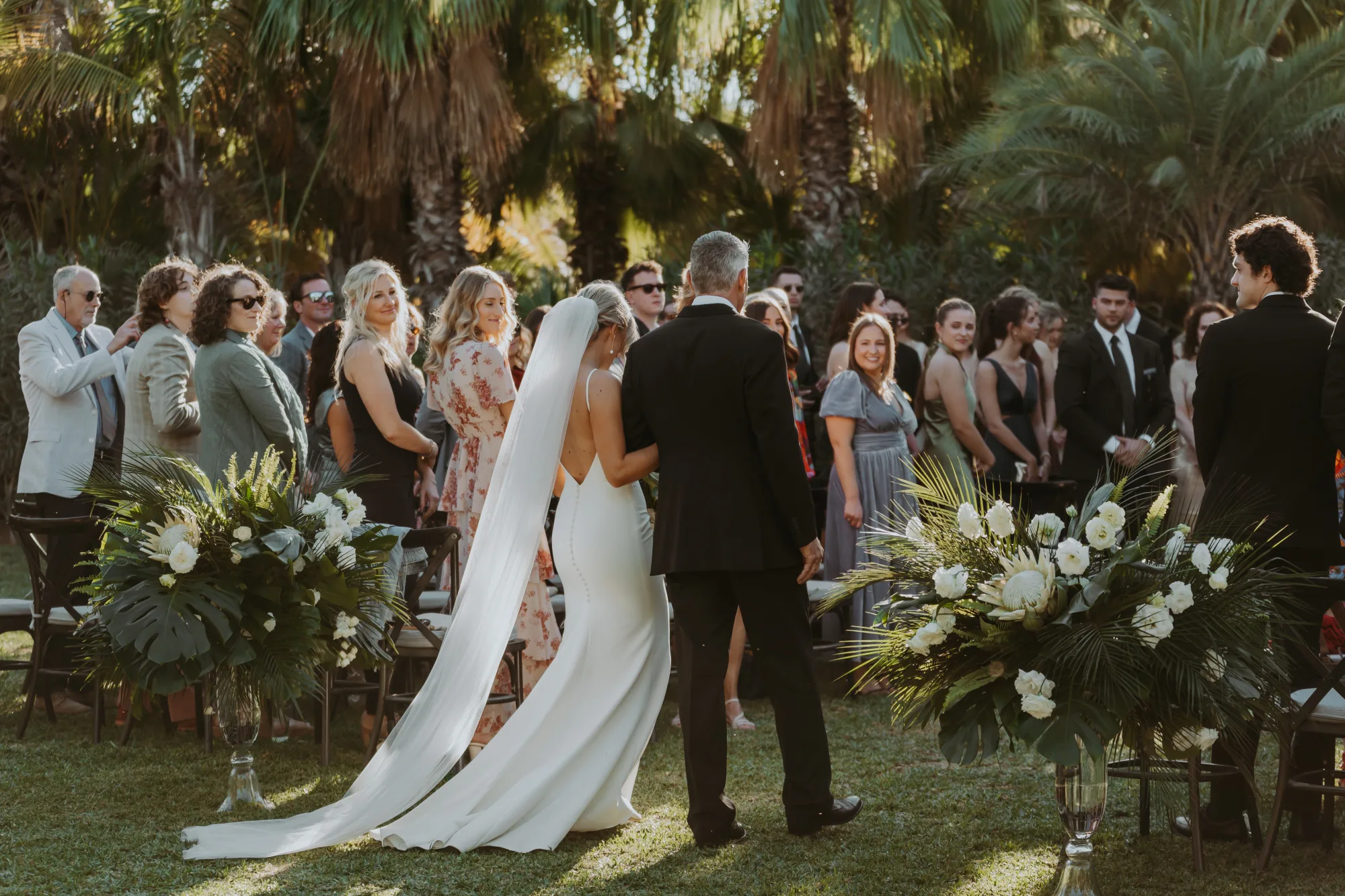 Bride walking down the aisle at a garden ceremony in Cabo
