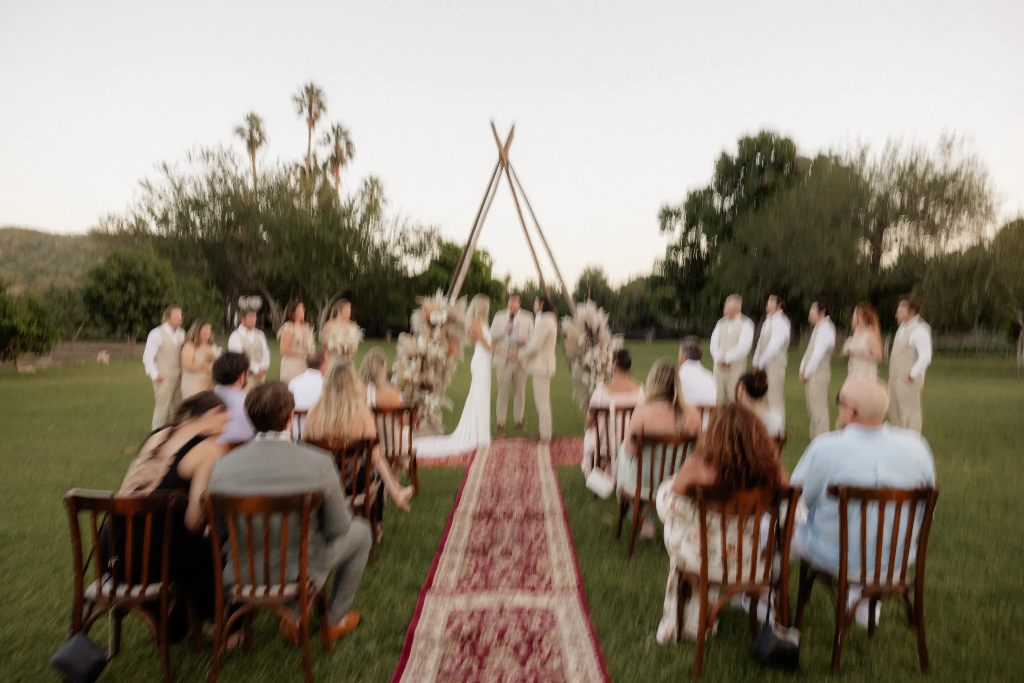 Guests seated for an outdoor wedding ceremony on a lawn in Cabo