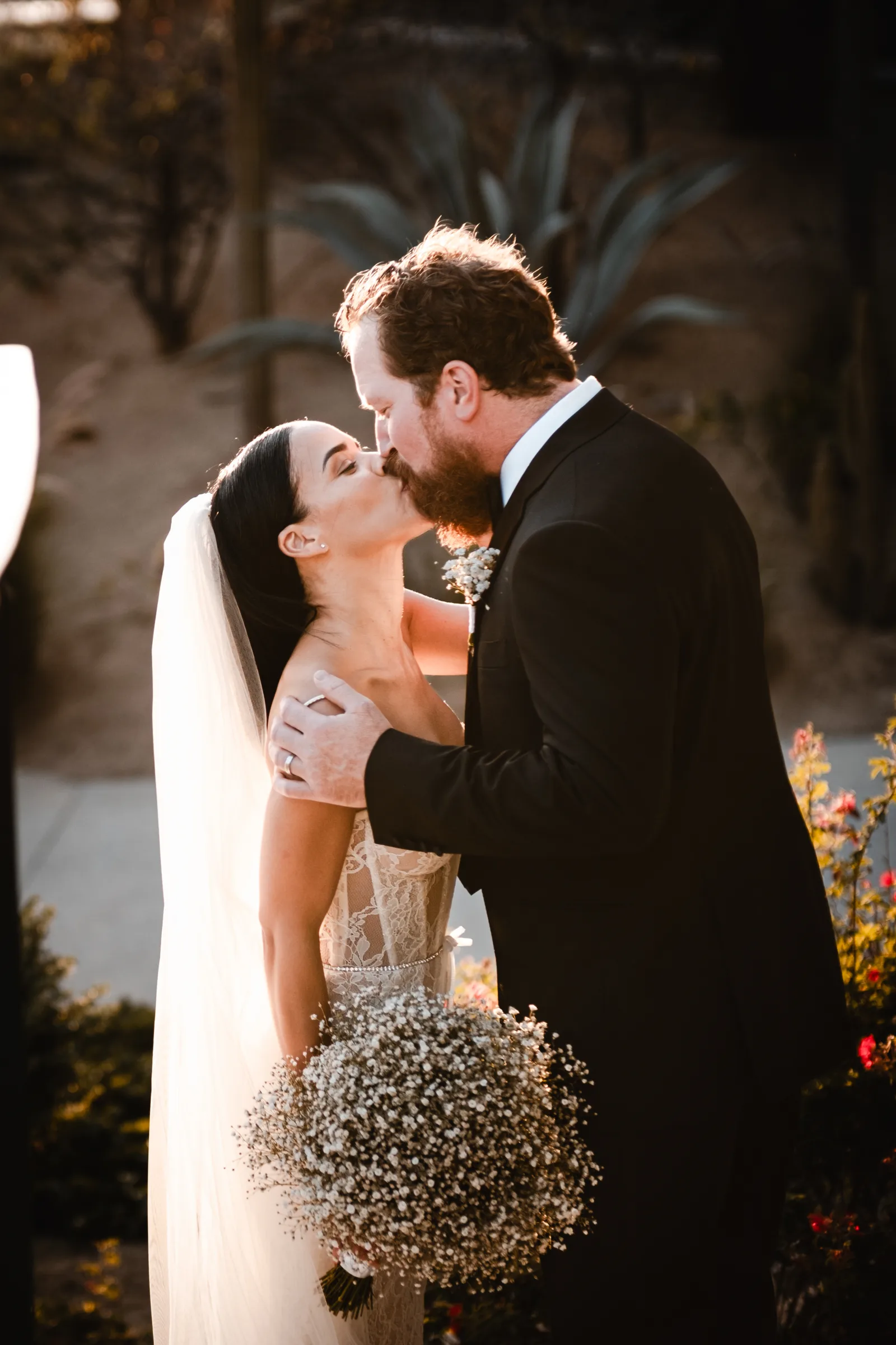 Couple kissing after their wedding ceremony in Cabo