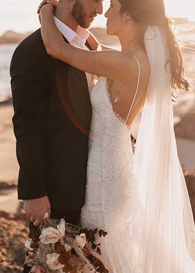 A couple shares a toast at their Cabo wedding.