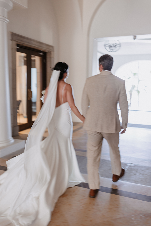 Hilton Cabo wedding setup — bride and groom walking on the beach