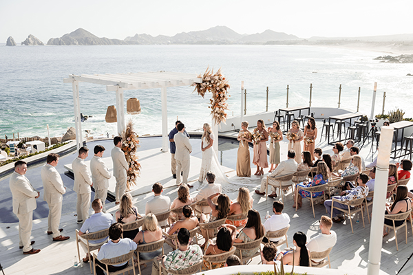 Sunset Monalisa wedding setup in Cabo San Lucas — ceremony with iconic Arch view
