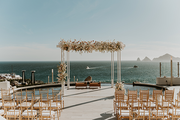 Sunset Monalisa wedding setup in Cabo San Lucas — bride and groom framed by Cabo landscape